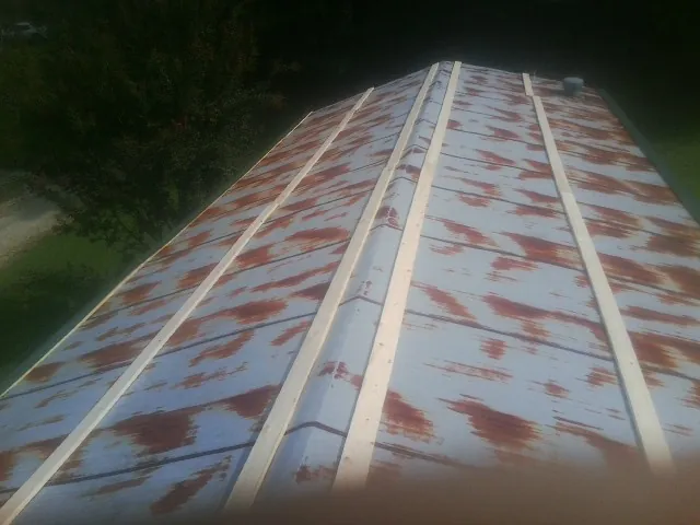 Rusted metal roof panels with new wood purlins before replacement — Storm Damage Roof Repair in Bloomsburg by Roofing Brothers