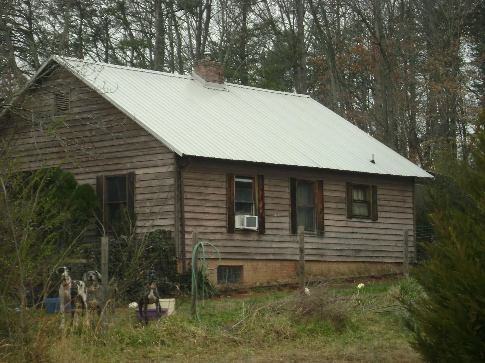 White metal roof on an old wood sided farmhouse, from a Asphalt Shingle Roof Repair job in Bloomsburg